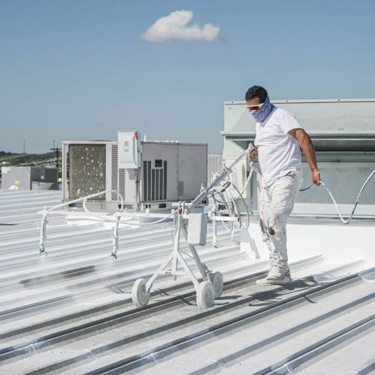 Roof Coatings - Stephens Commercial Painting - Painter Coats Metal Roof White